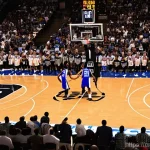 Home 15 농구 경기 중 심판과의 소통법 - **"The Referee's Multitasking Challenge"**
A high-angle, dynamic shot from behind a focused male...